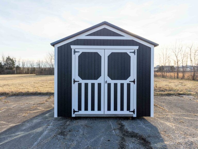 The front of a black gable shed with white trim on the sides and doors